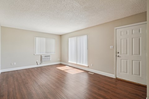 A room with a white door and a window with blinds.